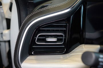 Closeup of car dashboard air vents near gear shift