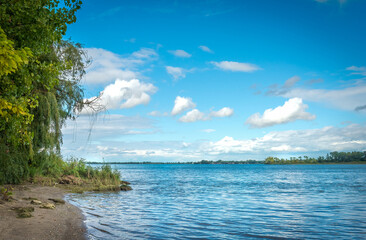 Clouds in summer heavenly sky over lake