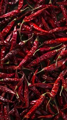 Close-up of a pile of red dried chili peppers, top view. Spicy ingredient and food concept