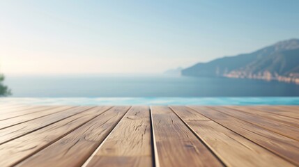 Obraz premium Wooden deck overlooking blue ocean and mountains.