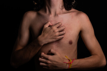 Man, shirtless, scratching his chest with his hand. Skin disease. Irritation, allergy.