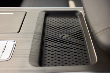 A thorough examination of the wireless phone charger installed within a cars cabin