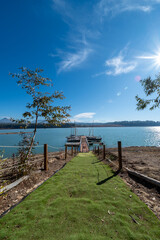 Wide angle photo of a pier with canoes and kayaks on a reservoir in Granada on a sunny winter morning