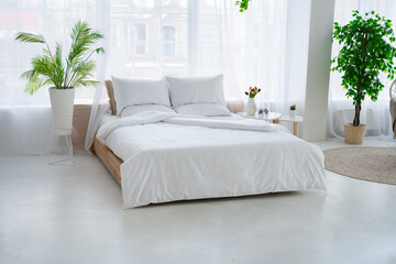 Bedroom with a large bed and flowers.