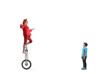 Child watching an acrobat riding a giraffe unicycle © Ljupco Smokovski