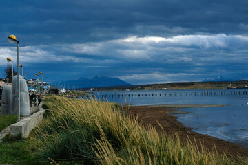 Puerto Natales Muelle Viejo Coast line argentina riverbank grass Golfo Almte Montt sky clouds