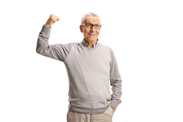 Naklejka premium Elderly man showing bicep muscle and looking at camera