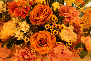 A bouquet of flowers with a mix of orange and pink flowers