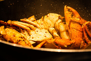 A pot of food with a variety of seafood, including crabs