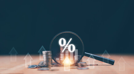 Coins moneys stacked and have magnifying glass with graph and percentage symbol inside. Finance and business growth concept. Financial increase interest rate or mortgage investment dividend.