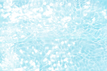 Blue water with ripples on the surface. Defocus blurred transparent blue colored clear calm water surface texture with splashes and bubbles. Water waves with shining pattern texture background.