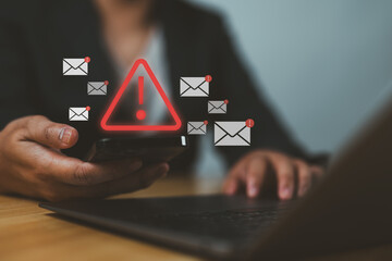 Email Spam concept. Person use smartphone with virtual screen of Spam email notification, warning notification and spam message. © Nirusmee