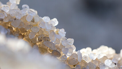 Microphotography, sand grains, close-up, texture, natural pattern, macro lens, microscopy, sunlight, close-up detail, sandy texture, beach grains.