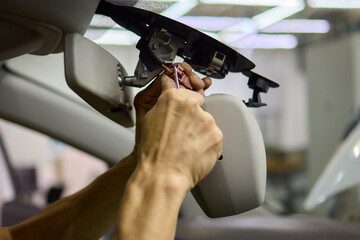 Expert car repair service for adjusting and fixing rearview mirror with precision