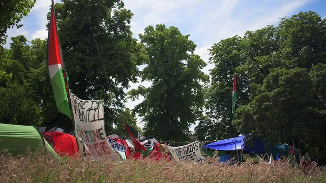 Students protesting peacefully for the Palestine-Israel conflict on the University of Bristol's campus. Flags and banners wave in the wind at the Palestine solidarity camp at Bristol University.