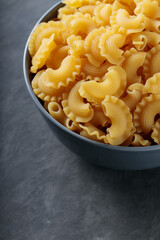 Dry Uncooked Italian Creste di Gallo Pasta in Bowl, Close Up