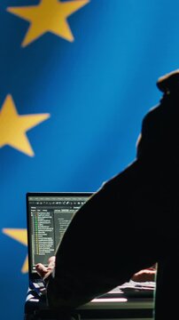 Vertical video EU alliance engineer protecting against fake accounts on social media promoting totalitarian governments interests. Technician working for European Union doing cybersecurity job, camera