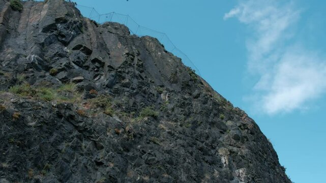 EDINBURGH - JUNE 24, 2024: View of the cliff face on Duddingston Low Road in Edinburgh, Scotland.