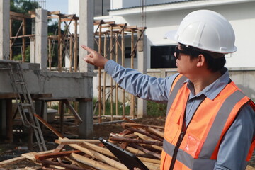 A team of engineers inspects beam work and installs concrete pillars according to the blueprint.