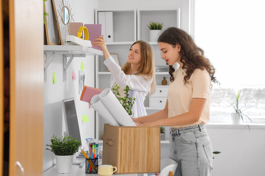 Female students unpacking things in dorm room on moving day