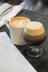 A cup of cappuccino and a cold brew