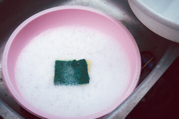 A dirty dish with a sponge in it