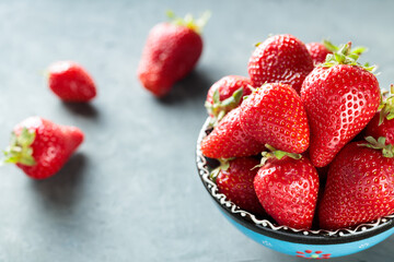 Fresh Red Strawberries in Bowl On Gray Concrete Background