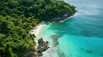 Aerial view of a pristine coastline with crystal-clear waters, white sand beaches, and lush vegetation