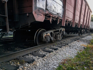 Naklejka premium The wreck of railway wagons. A railway carriage derailed during daylight hours. The railway car as a result of the accident came off the rails. Traffic accident on the railway.