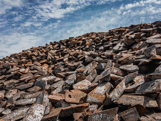 The shape of cast iron: ingots, ingots in a solid state. Cast iron ingots are stored in a...