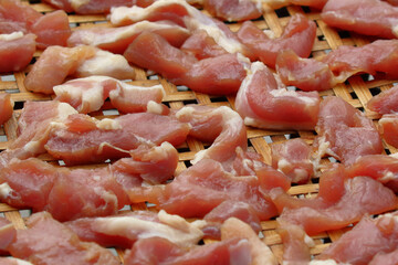 Fresh pork pieces that are dried in the sun for cooking. Food preservation