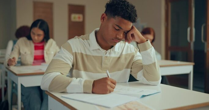 High school, depression and tired boy in classroom with test anxiety, fatigue or overthinking assessment questions. Education, learning and student frustrated by exam stress, project and burnout