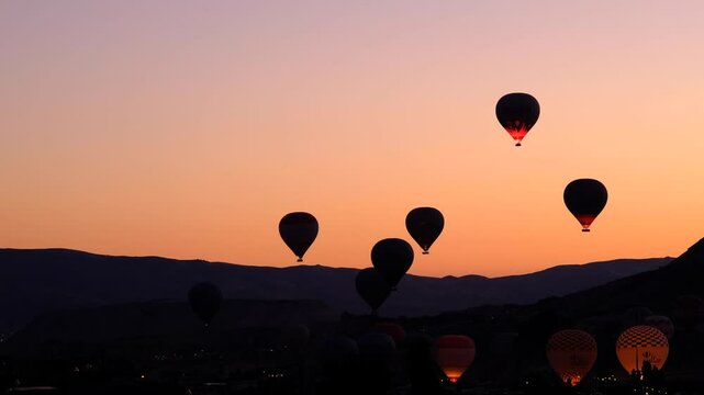 Hot air balloons flying in the sky at sunrise