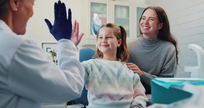 Girl, child and happy with high five for dentist for success of treatment, friendly and build trust for procedure. Pediatric, patient and hand gesture for well done, good behavior and celebration.