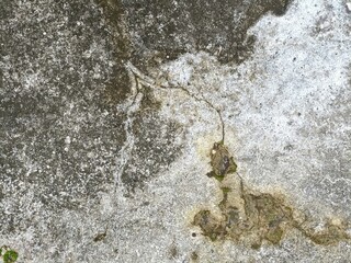 Funky stained cement surface with irregular patches of contrasting shades of gray