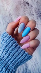 A person holding blue and pink nails with a furry sweater.