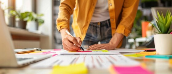 Person planning a social media calendar with colorful sticky notes, organized and creative digital marketing, and content scheduling