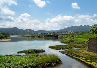 Peaceful lake nearby the building with cloudy blue sky, in Jinshan, New Taipei City, Taiwan.
