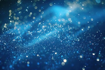 Abstract blue sparkles with bokeh effect and light rays