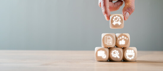 Wooden blocks with icons symbolizing the International Organization for Standardization concept,...