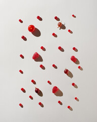 Raspberries, tomato, gooseberries and currants on white