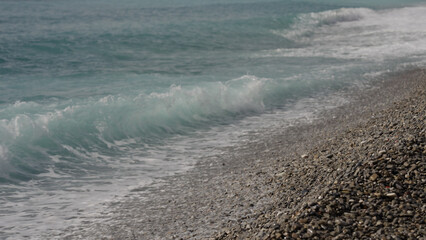 mediterranean sea waves crushing on a pebble beach