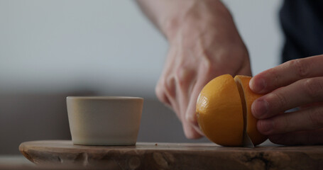 man cut sweet lemon on olive board