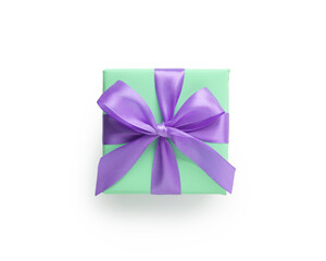 Top view of green gift box with purple ribbon bow isolated on white background