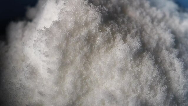 Small crystals of white sea salt rotate video. Macro. Epsom salt particles. Slow motion video. High quality 4k footage.