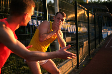 athletes tell each other funny stories during a break in training