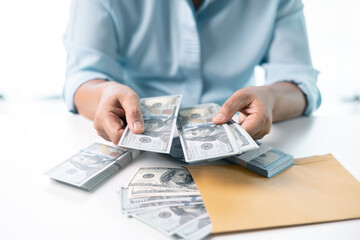 Woman carefully counted the dollar bills in her hand, managing her finances and saving money for future expenses. dollar, hand, money, cash, woman, finance, currency, bill, banknote, saving, business.