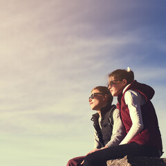 Space, view and couple on mountain peak for travel, adventure or hiking journey in outdoor mockup. Sky, relax or people on rock together for holiday vacation, love or trekking to explore on cliff