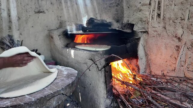 preparing bread in a traditional Dagestan village bakery. Bread is a flatbread baked in a Koryuk oven, common in the cuisine of the North Caucasus.