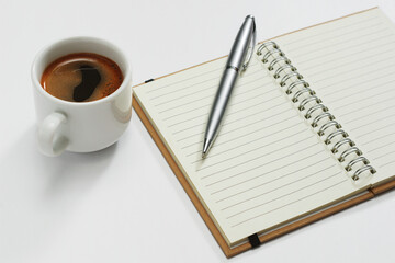 Coffee and notepad with pen